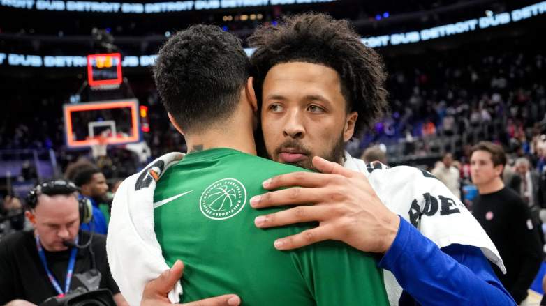 Cade Cunningham of the Detroit Pistons embraces Jayson Tatum of the Boston Celtics