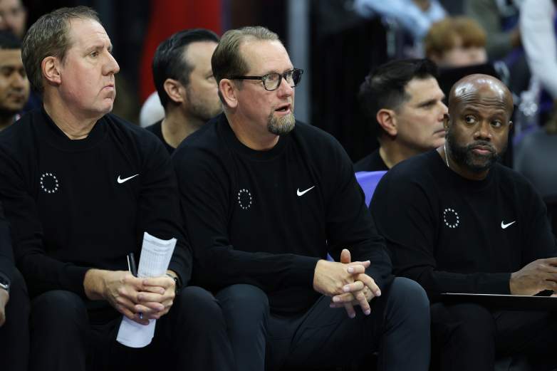 Nick Nurse sits on the side line during an NBA game.