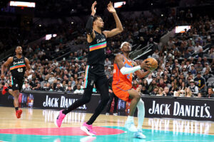 SAN ANTONIO, TEXAS - DECEMBER 23: Shai Gilgeous-Alexander #2 of the Oklahoma City Thunder is fouled on a layup attempt by Victor Wembanyama #1 of the San Antonio Spurs during the game at Frost Bank Center on December 23, 2025 in San Antonio, Texas. (Photo by Kenneth Richmond/Getty Images)
