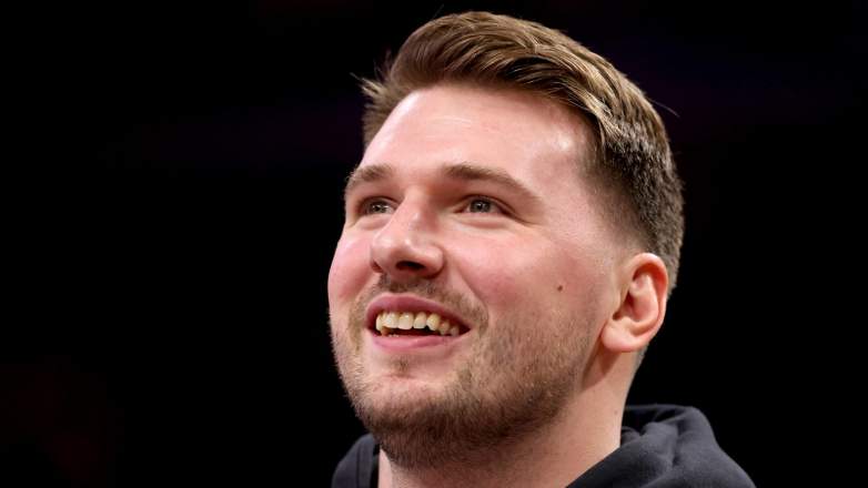 Lakers star Luka Doncic smiling on bench during playoff game while recovering from injury