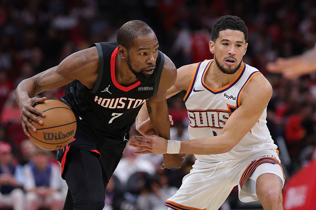 HOUSTON, TEXAS - JANUARY 05: Kevin Durant #7 of the Houston Rockets drives against Devin Booker #1 of the Phoenix Suns during the second half at Toyota Center on January 05, 2026 in Houston, Texas. NOTE TO USER: User expressly acknowledges and agrees that, by downloading and or using this photograph, User is consenting to the terms and conditions of the Getty Images License Agreement. (Photo by Alex Slitz/Getty Images)