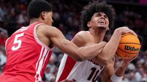 Koa Peat #10 of the Arizona Wildcats drives against Chris Cenac Jr. #5 of the Houston Cougars. Both are top picks in the 2026 NBA mock draft.