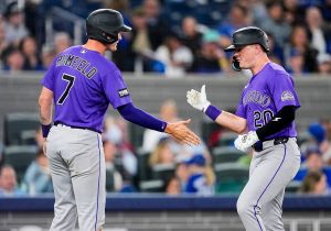 TORONTO, CANADA - MARCH 30: Troy Johnston #20 of the Colorado Rockies celebrates a two run home run with TJ Rumfield #7 against the Toronto Blue Jays during the sixth inning in their MLB game at the Rogers Centre on March 30, 2026 in Toronto, Ontario, Canada. (Photo by Mark Blinch/Getty Images)