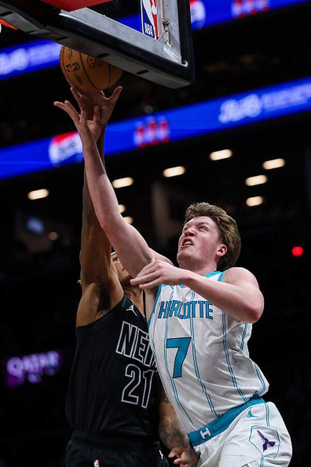 Kon Knueppel of the Charlotte Hornets shoots the ball against Noah Clowney of the Brooklyn Nets.