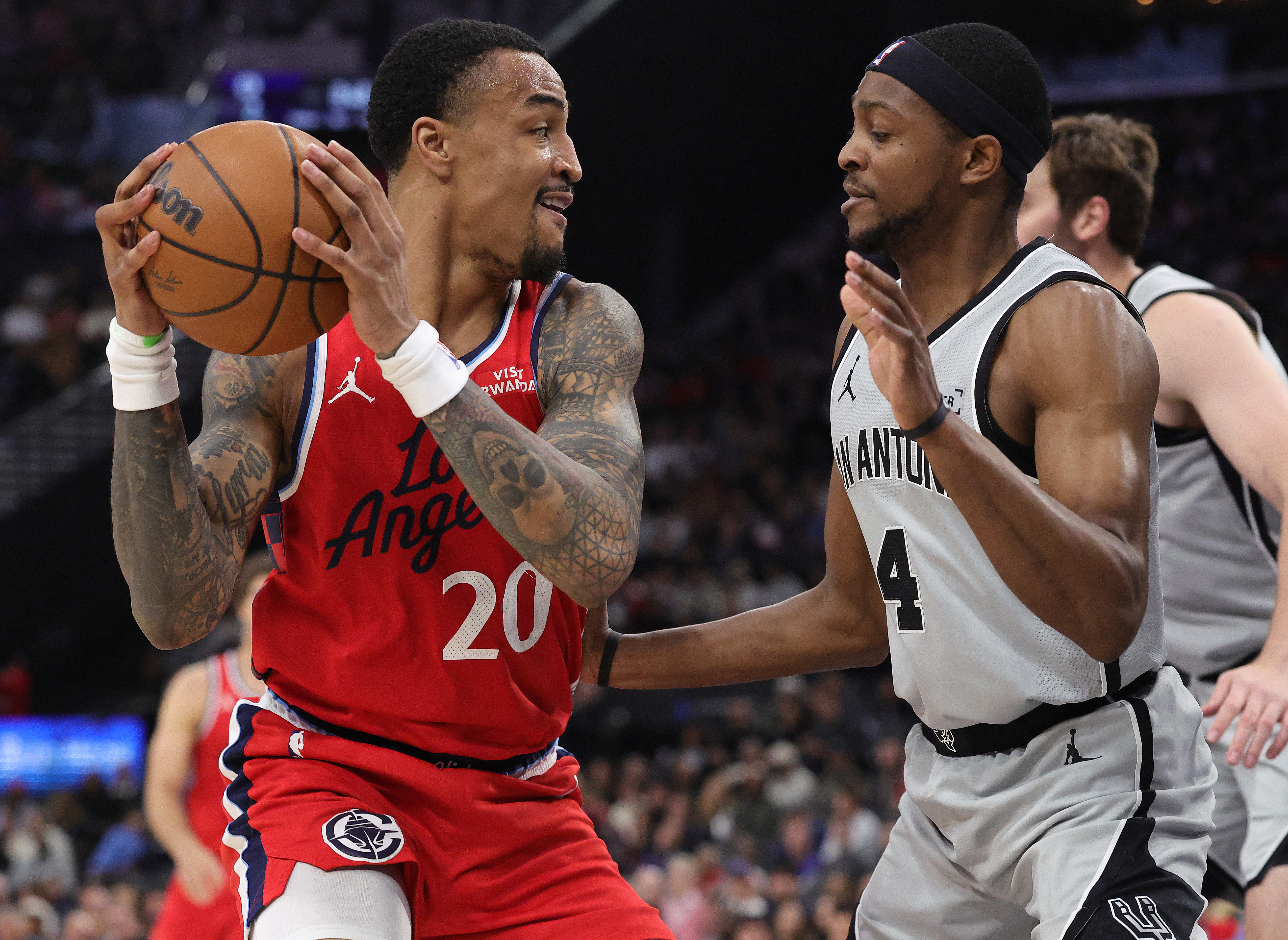 Clippers forward John Collins handles the ball as San Antonio...