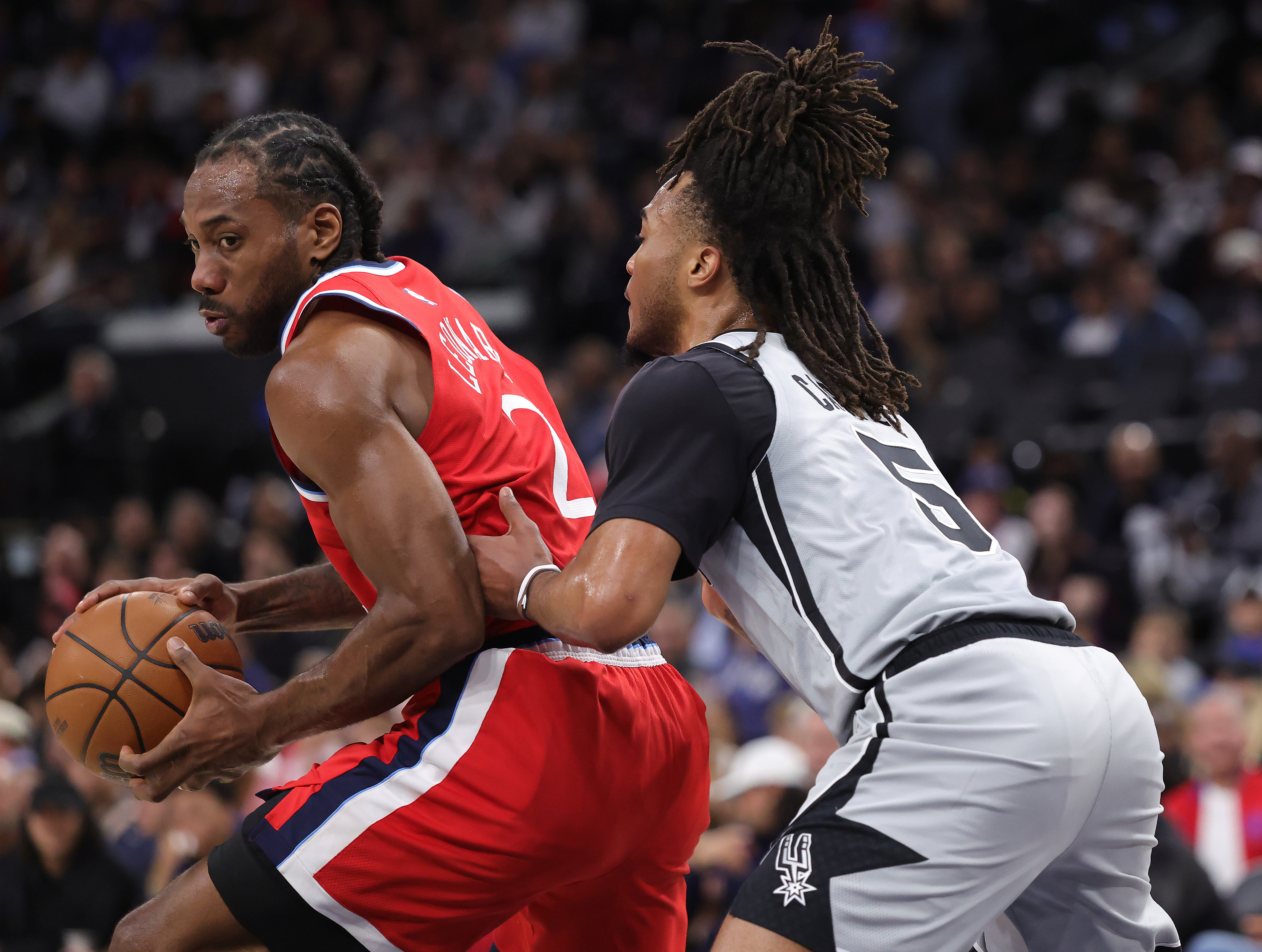 Clippers star Kawhi Leonard handles the ball as the San...