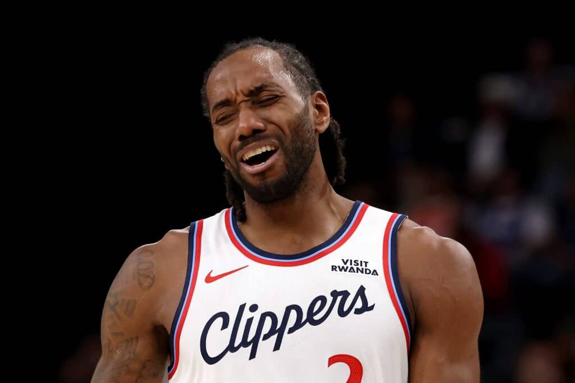 Kawhi Leonard reacts to a play — with his eyes closed and mouth open — during a game.