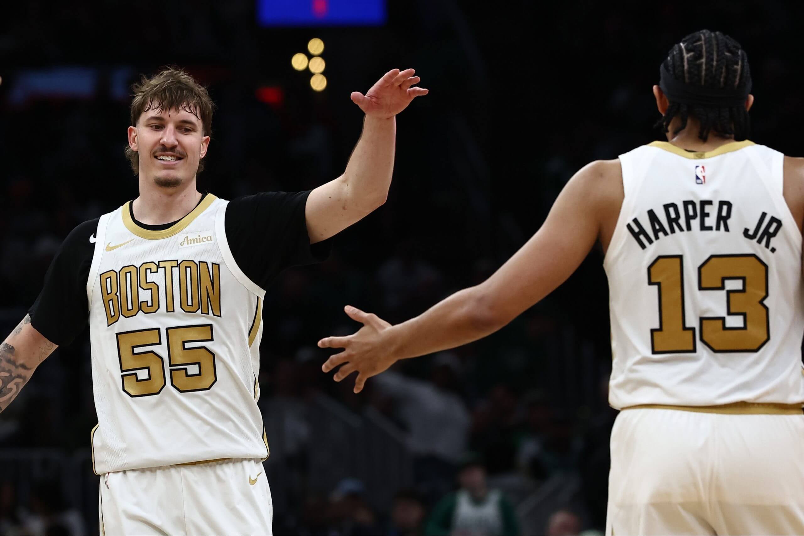 Boston's Baylor Scheierman and Ron Harper Jr. celebrate during a game.