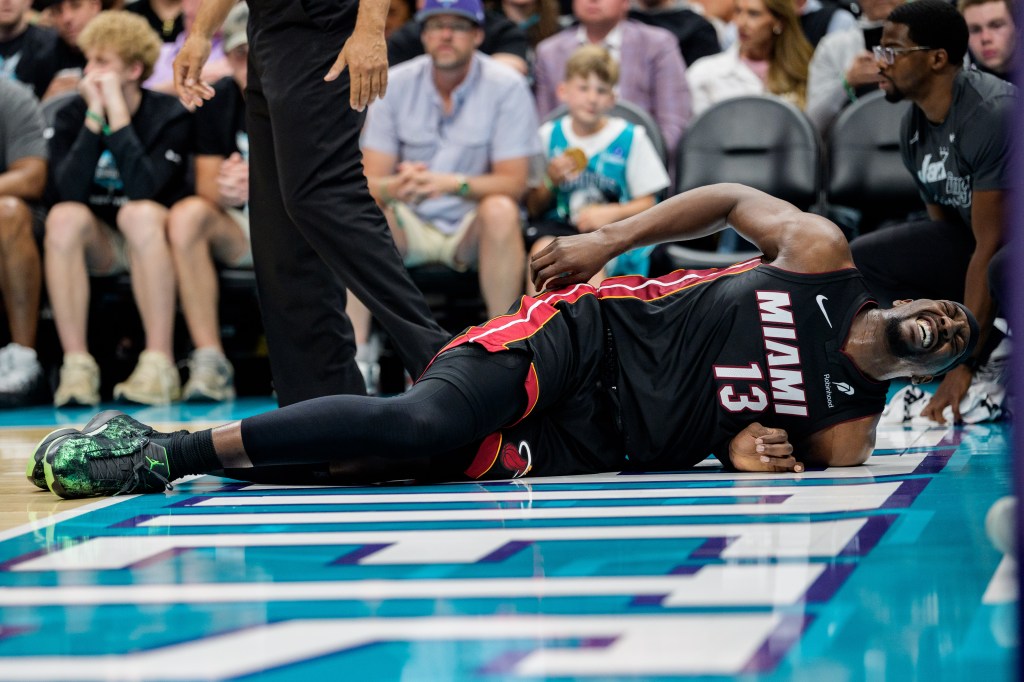 Bam Adebayo reacts after a fall in the first half against the Charlotte Hornets during their game at Spectrum Center on April 14, 2026 in Charlotte, North Carolina. 
