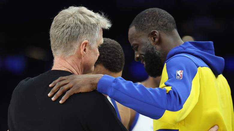 Head coach Steve Kerr, Stephen Curry and Draymond Green of the Golden State Warriors hug