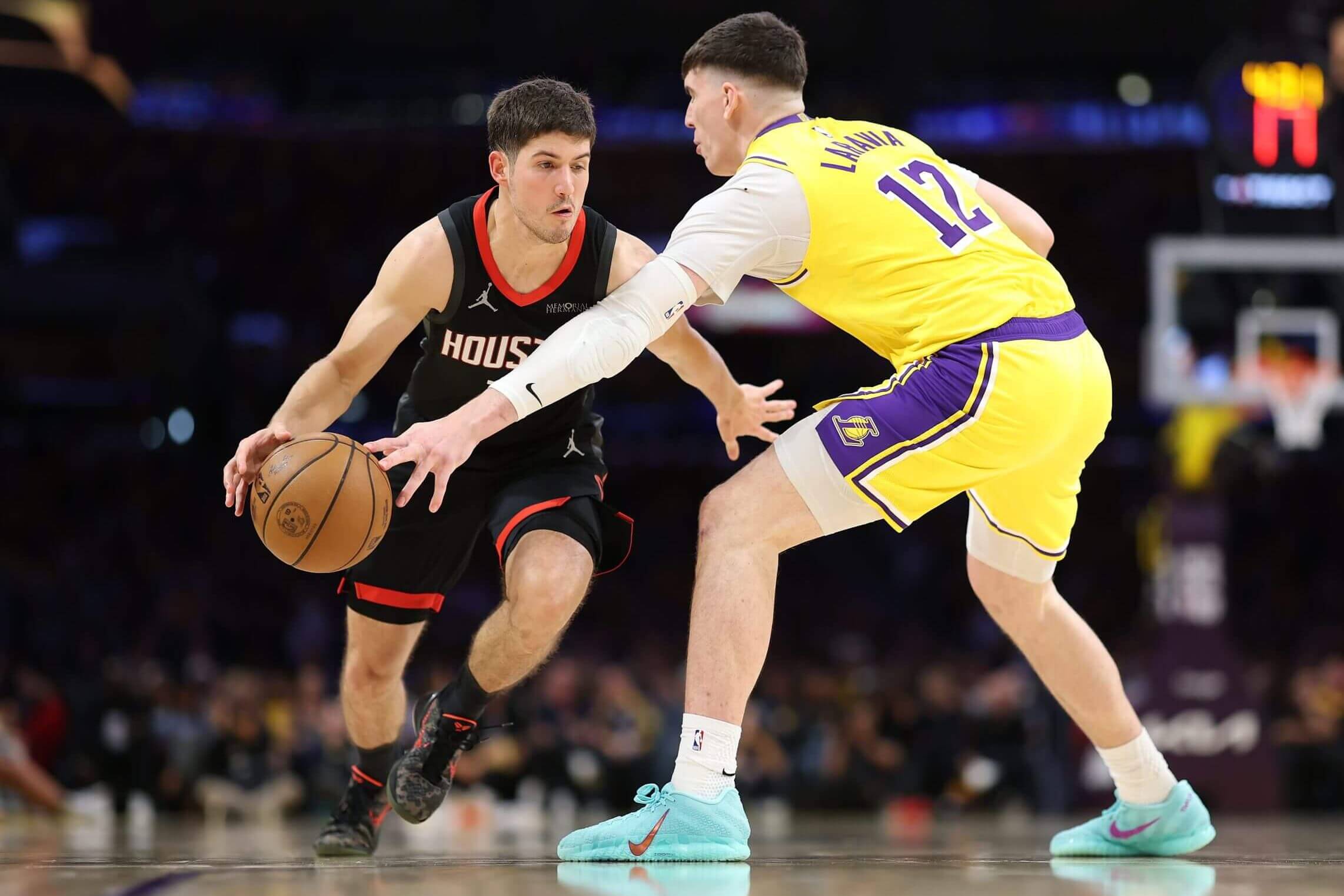 Houston's Reed Sheppard dribbles at the Lakers' Jake LaRavia.