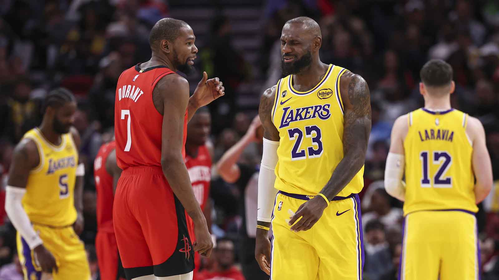 Houston Rockets forward Kevin Durant (7) talks with Los Angeles Lakers forward LeBron James (23) on the court during the second quarter at Toyota Center.