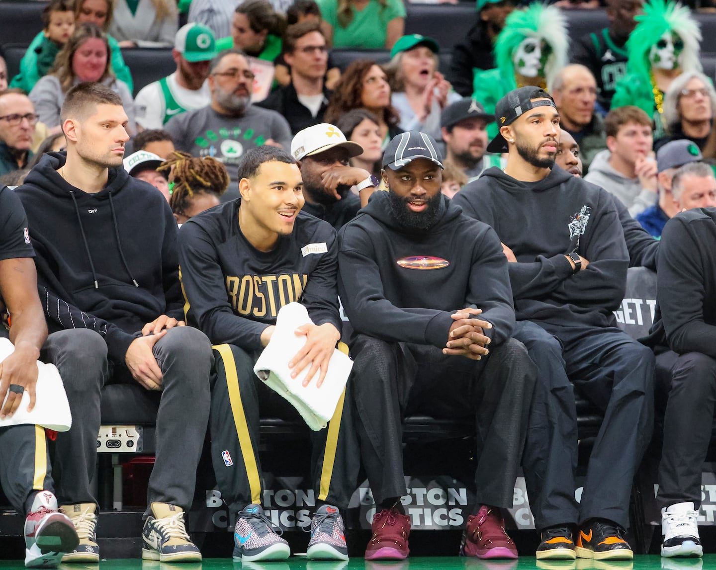 Celtics (from left) Nikola Vucevic, John Tonje, Jaylen Brown and Jayson Tatum were enjoying the action from the bench in Sunday's regular season finale.