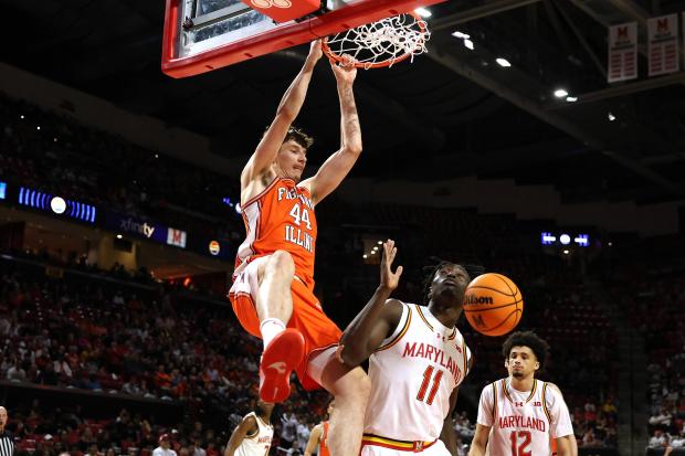 Illinois center Zvonimir Ivišić (44) dunks over Maryland guard George Turkson Jr. (11) during the first half of an NCAA college basketball game, Sunday, March 8, 2026, in College Park, Md. (AP Photo/Daniel Kucin Jr.)