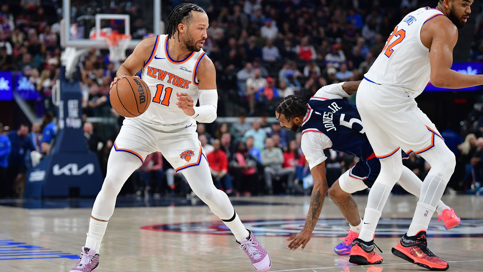 New York Knicks guard Jalen Brunson (11) controls the ball as center Karl-Anthony Towns (32) provides coverage against Los Angeles Clippers forward Derrick Jones Jr. (5) during the first half at Intuit Dome. 
