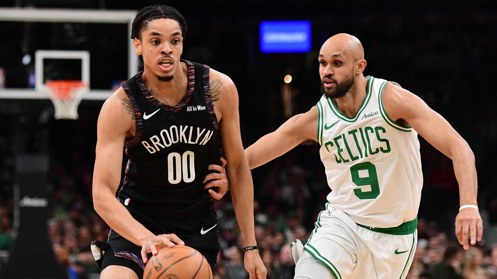 Brooklyn Nets forward Josh Minot (00) controls the ball while Boston Celtics guard Derrick White (9) defends during the first half at TD Garden.