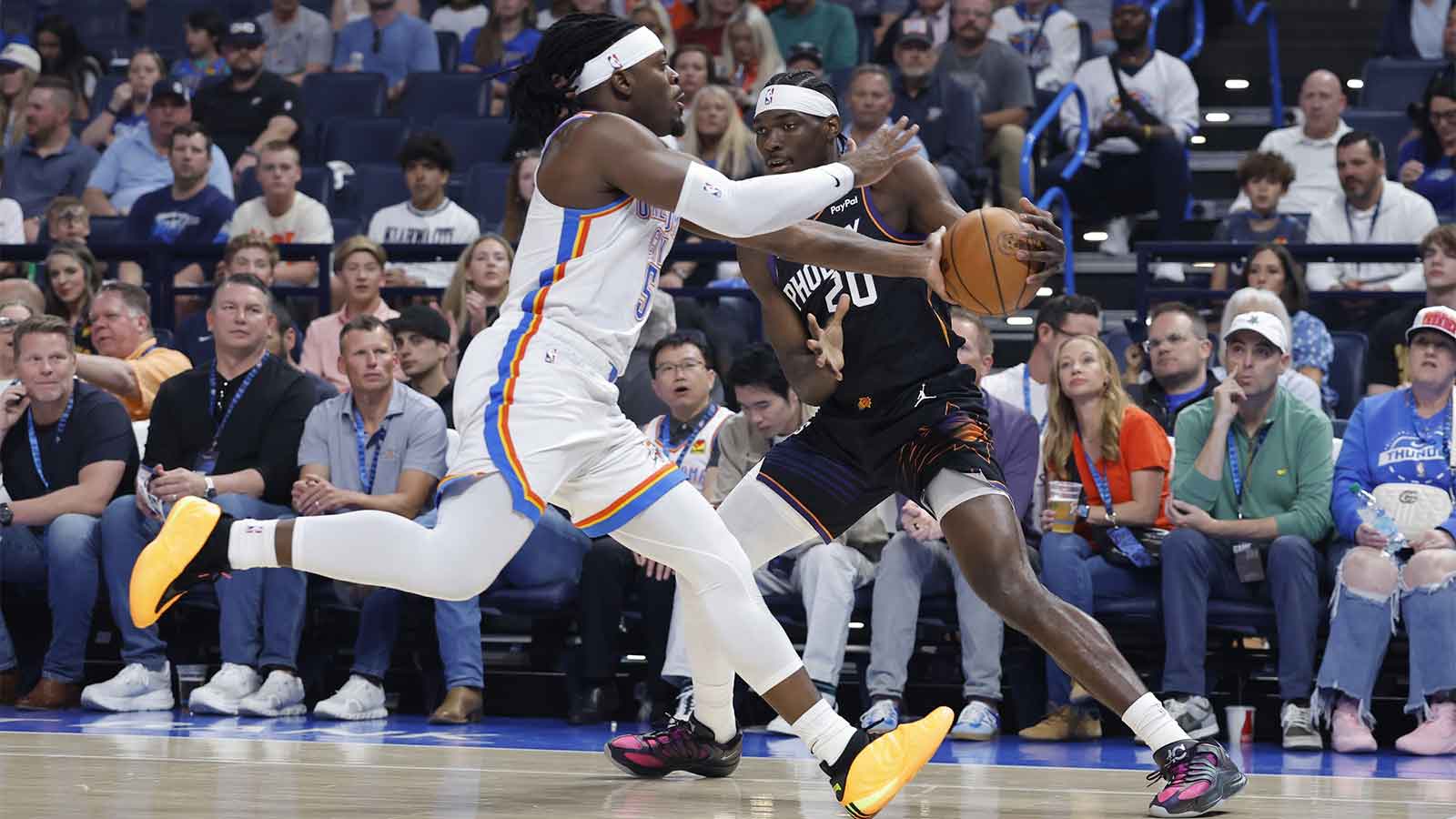 Oklahoma City Thunder guard Luguentz Dort (5) defends a play by Phoenix Suns forward Rasheer Fleming (20) during the first quarter at Paycom Center. 