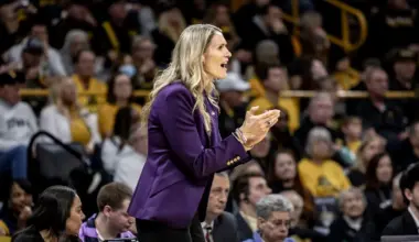 a woman coach talking to her team players from the sidelines