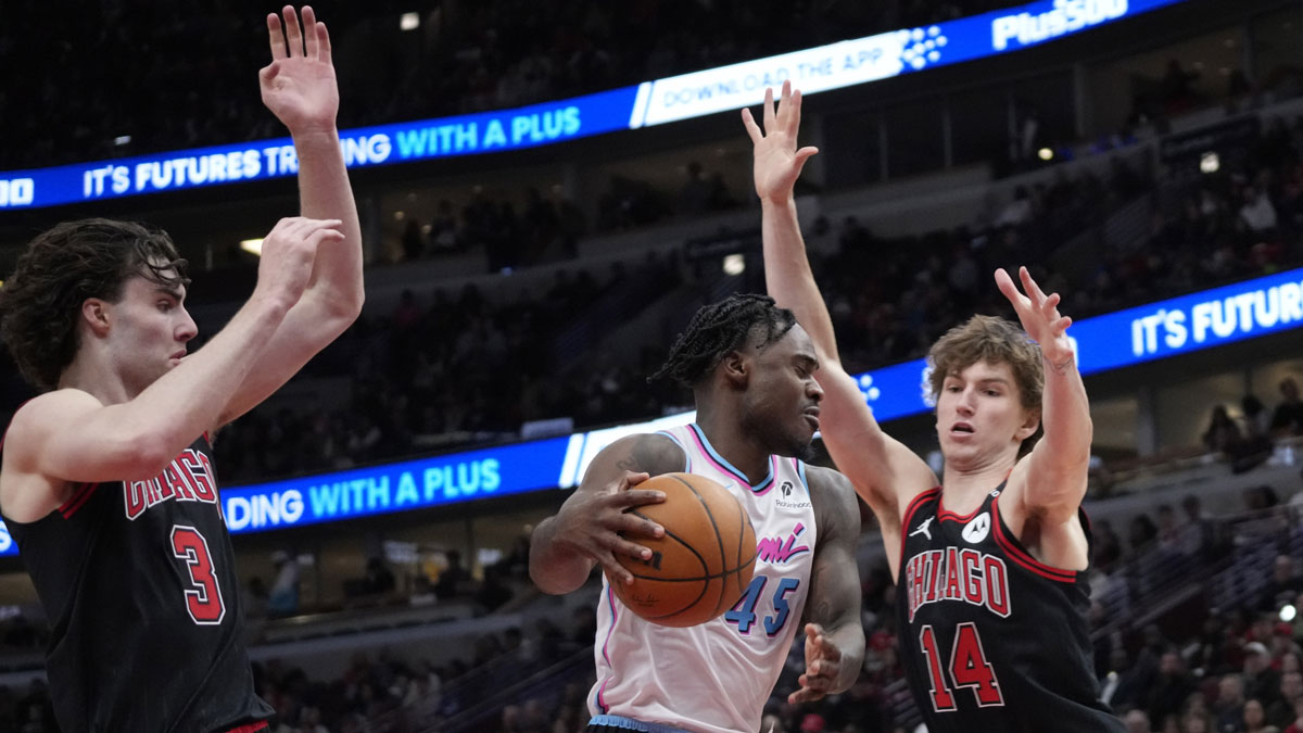 Chicago Bulls guard Josh Giddey (3) and forward Matas Buzelis (14) defends Miami Heat guard Davion Mitchell (45) during the second half at United Center.
