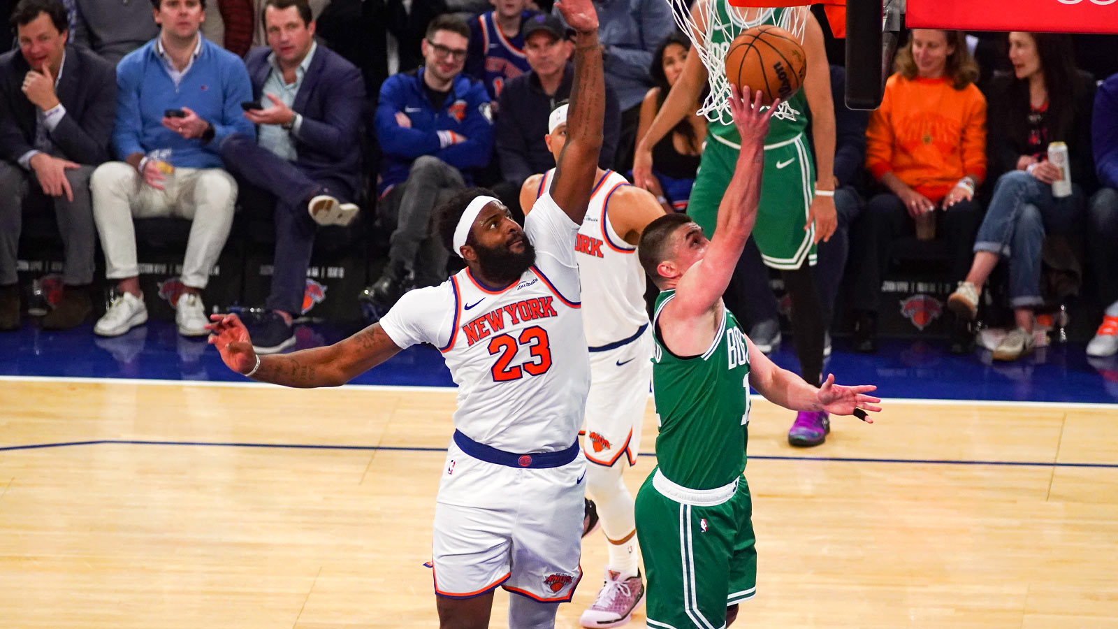 New York Knicks center Mitchell Robinson (23) defends a layup from Boston Celtics guard Payton Pritchard (11) during the third quarter at Madison Square Garden.