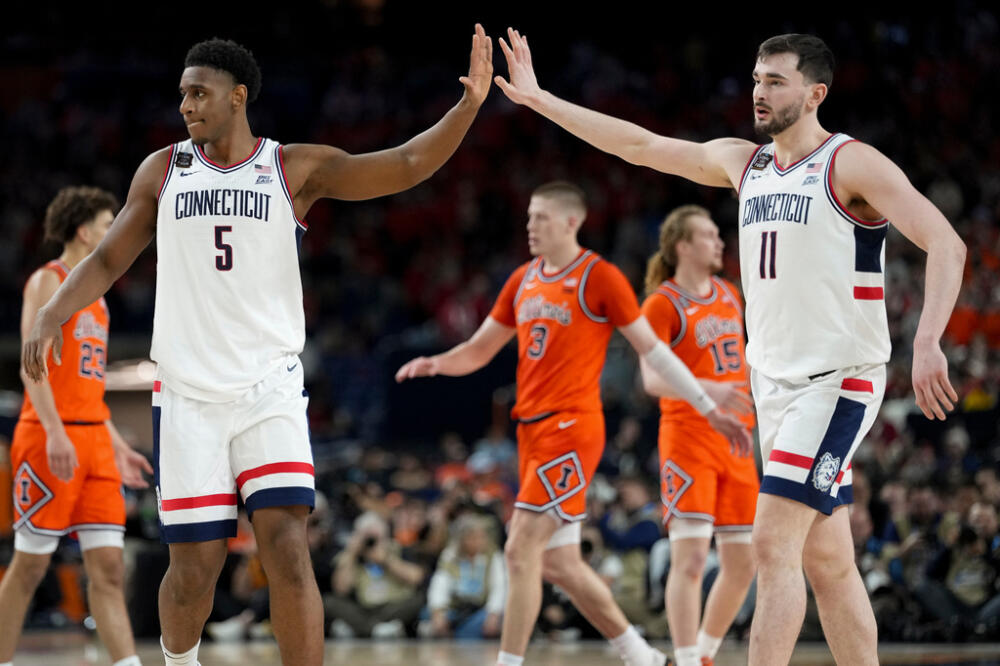 UConn forward Tarris Reed Jr. (5) high fives forward Alex Karaban (11) during the second half of an NCAA college basketball tournament semifinal game against Illinois at the Final Four, Saturday, April 4, 2026, in Indianapolis. (Abbie Parr/AP)