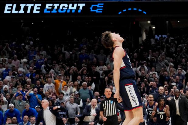 UConn guard Braylon Mullins (24) celebrates after a basket against Duke during the second half in the Elite Eight of the NCAA college basketball tournament, Sunday, March 29, 2026, in Washington. (AP Photo/Stephanie Scarbrough)
