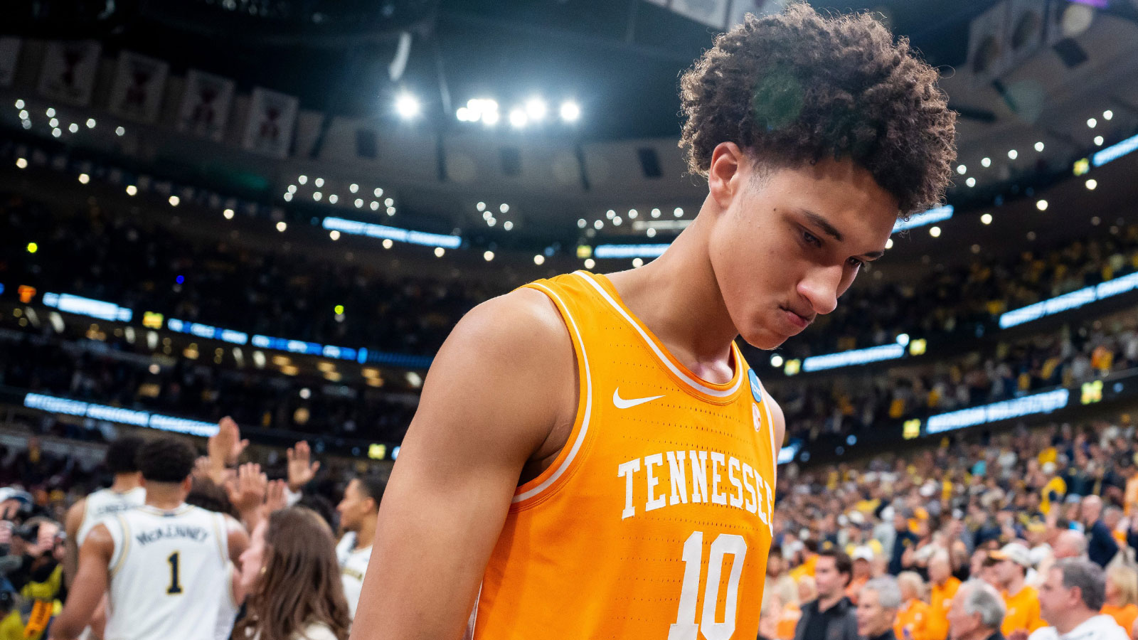Tennessee forward Nate Ament (10) walks off the court as Michigan players celebrate their Final Four berth behind him after a NCAA Tournament Elite 8 game between Tennessee and Michigan at the United Center in Chicago on March 29, 2026.