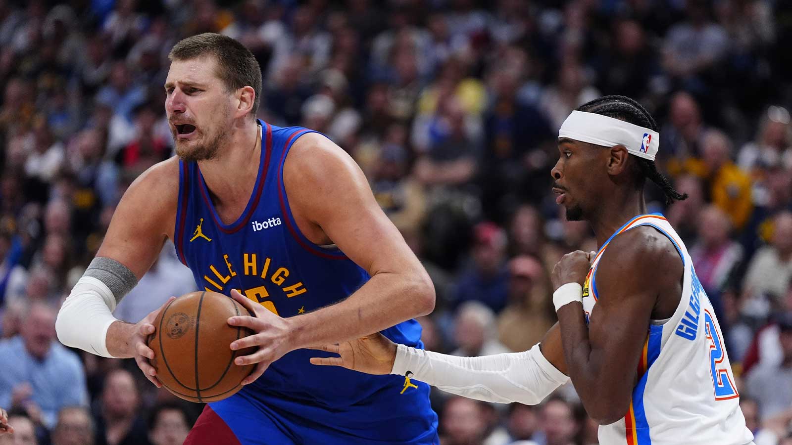 Thunder guard Shai Gilgeous-Alexander (2) defends on Denver Nuggets center Nikola Jokic (15) in the second half during game three of the second round for the 2025 NBA Playoffs at Ball Arena