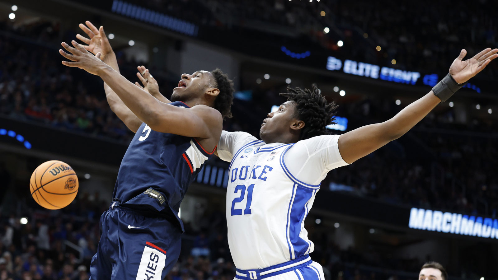 UConn Huskies forward Tarris Reed Jr. (5) loses the ball as he goes to the basket against Duke Blue Devils center Patrick Ngongba (21)in the second half during an Elite Eight game of the East Regional of the men's 2026 NCAA Tournament at Capital One Arena. 