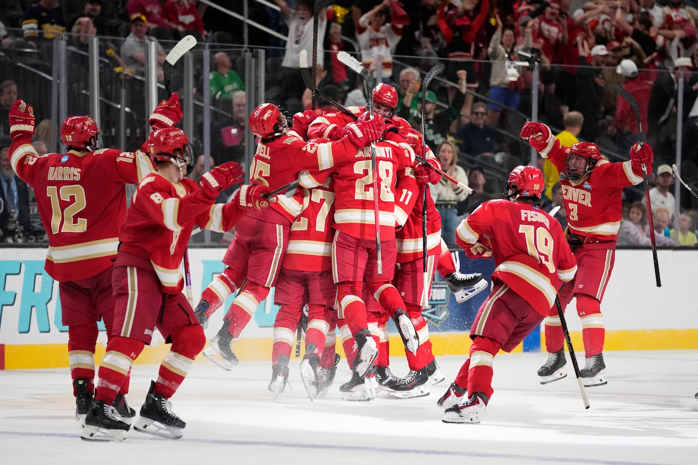 Denver players celebrated after Kent Anderson's goal in double overtime lifted the team to a 4-3 win over Michigan.