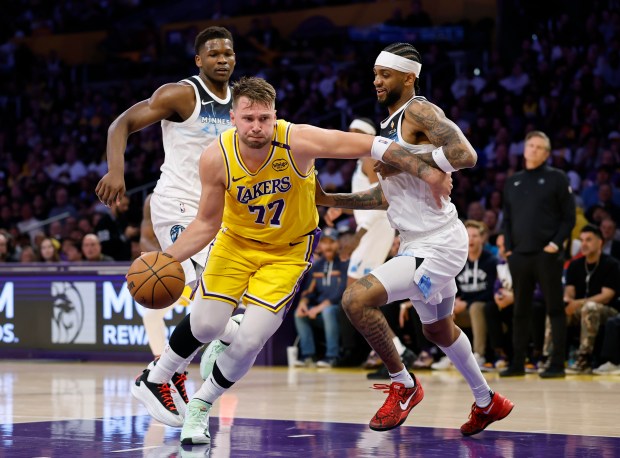 Luka Doncic #77 of the Los Angeles Lakers drives to the basket past Nickeil Alexander-Walker #9 and Anthony Edwards #5 of the Minnesota Timberwolves during a 111-102 Lakers win at Crypto.com Arena on Feb. 27, 2025 in Los Angeles, California. (Photo by Harry How/Getty Images) 