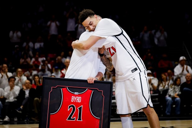 SDSU coach Brian Dutcher hugs Miles Byrd during Senior Night festivities prior the Aztecs' game against UNLV at Viejas Arena on March 6. (Meg McLaughlin / The San Diego Union-Tribune)