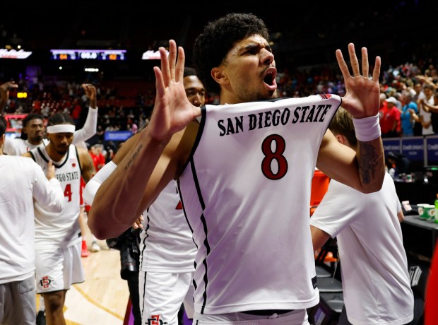 SDSU forward Tae Simmons celebrates a win against New Mexico in the semifinal of the Mountain West tournament in Las Vegas on March 13. (K.C. Alfred / The San Diego Union-Tribune)