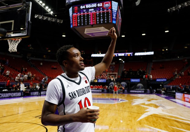 SDSU guard BJ Davis waves to the crowd after a win against New Mexico in the semifinal of the Mountain West tournament in Las Vegas on March 13. (K.C. Alfred / The San Diego Union-Tribune)