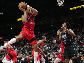 Raptors' Scottie Barnes grabs a rebound versus Brooklyn