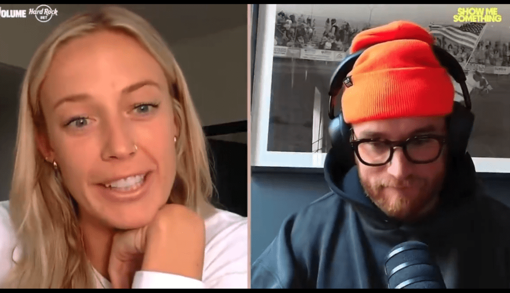 Two people, a blonde woman and a bearded man in a beanie and headphones, in a video call.