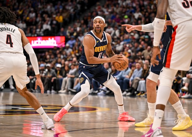 Bruce Brown (11) of the Denver Nuggets handles the ball as Matisse Thybulle (4) of the Portland Trail Blazers defends during the first quarter at Ball Arena in Denver on Monday, April 6, 2026. (Photo by AAron Ontiveroz/The Denver Post)