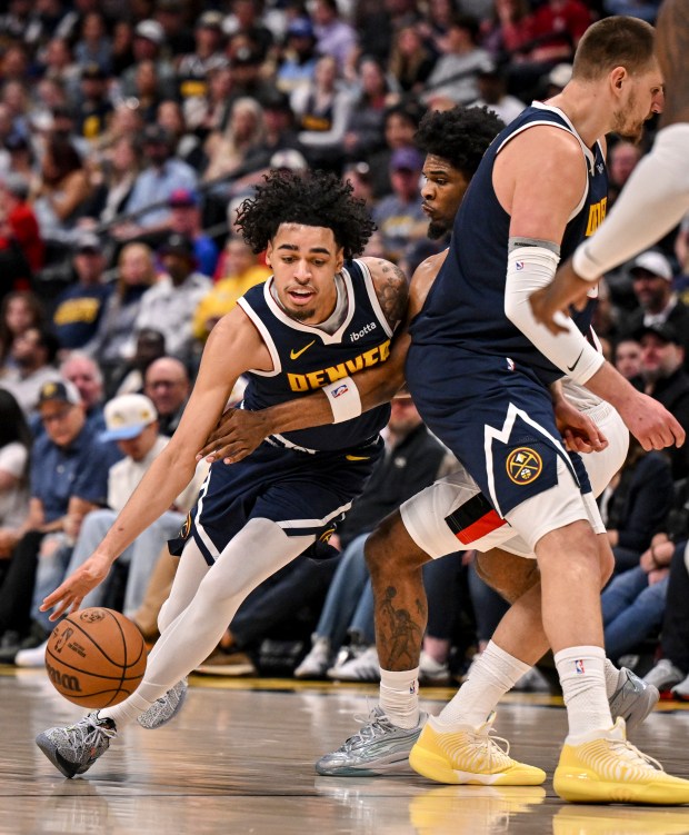 Julian Strawther (3) of the Denver Nuggets draws a foul from Scoot Henderson (00) of the Portland Trail Blazers as Nikola Jokic (15) screens during the second quarter at Ball Arena in Denver on Monday, April 6, 2026. (Photo by AAron Ontiveroz/The Denver Post)