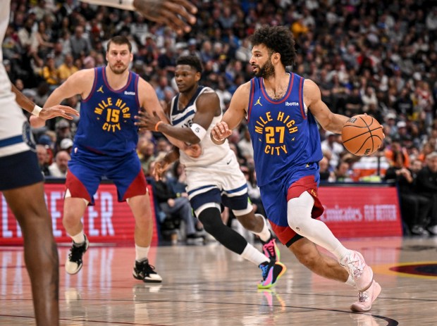 Jamal Murray (27) of the Denver Nuggets handles as Anthony Edwards (5) of the Minnesota Timberwolves defends Nikola Jokic (15) during the third quarter at Ball Arena in Denver on Sunday, March 1, 2026. (Photo by AAron Ontiveroz/The Denver Post)