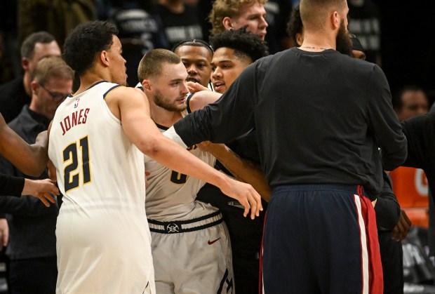Nikola Jokic (15) of the Denver Nuggets and Julius Randle (30) of the Minnesota Timberwolves engage in a melee with a second to play as Spencer Jones (21), Jonas Valanciunas (17) and Christian Braun (0) enter the fracas during the fourth quarter of the Timberwolves' 112-96 win in game four of their NBA Playoffs series at the Target Center in Minneapolis, Minnesota on Saturday, April 25, 2026. Both Jokic and Randle were ejected as a result. (Photo by AAron Ontiveroz/The Denver Post)