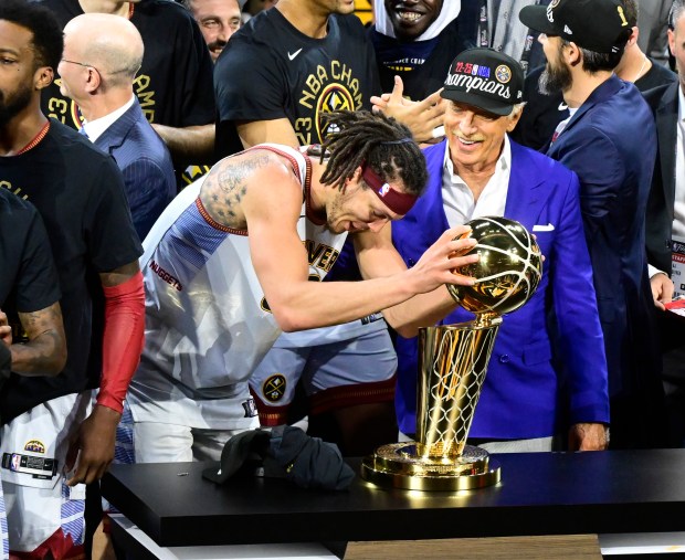 DENVER, CO - JUNE 12: Aaron Gordon (50) of the Denver Nuggets wraps his hands around the NBA championship trophy on stage after winning the championship against the Miami Heat at Ball Arena June 12, 2023. (Photo by Andy Cross/The Denver Post)