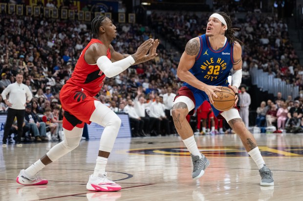 Forward/guard RJ Barrett (9) of the Toronto Raptors defends forward Aaron Gordon (32) of the Denver Nuggets during the second half of a 121-115 Nuggets win on Friday, March 20, 2026, at Ball Arena in Denver. (Photo by Timothy Hurst/The Denver Post)