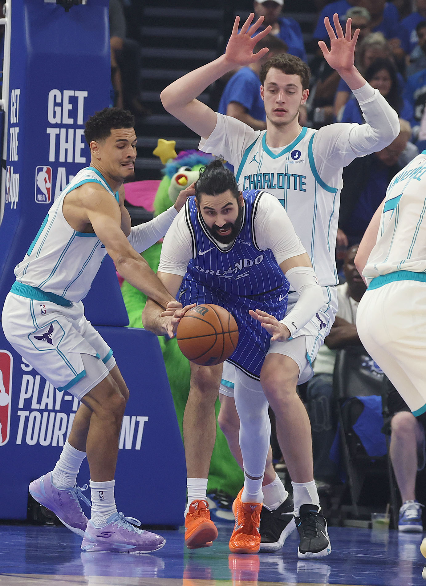 Orlando center Goga Bitadze (middle) goes for a loose ball...