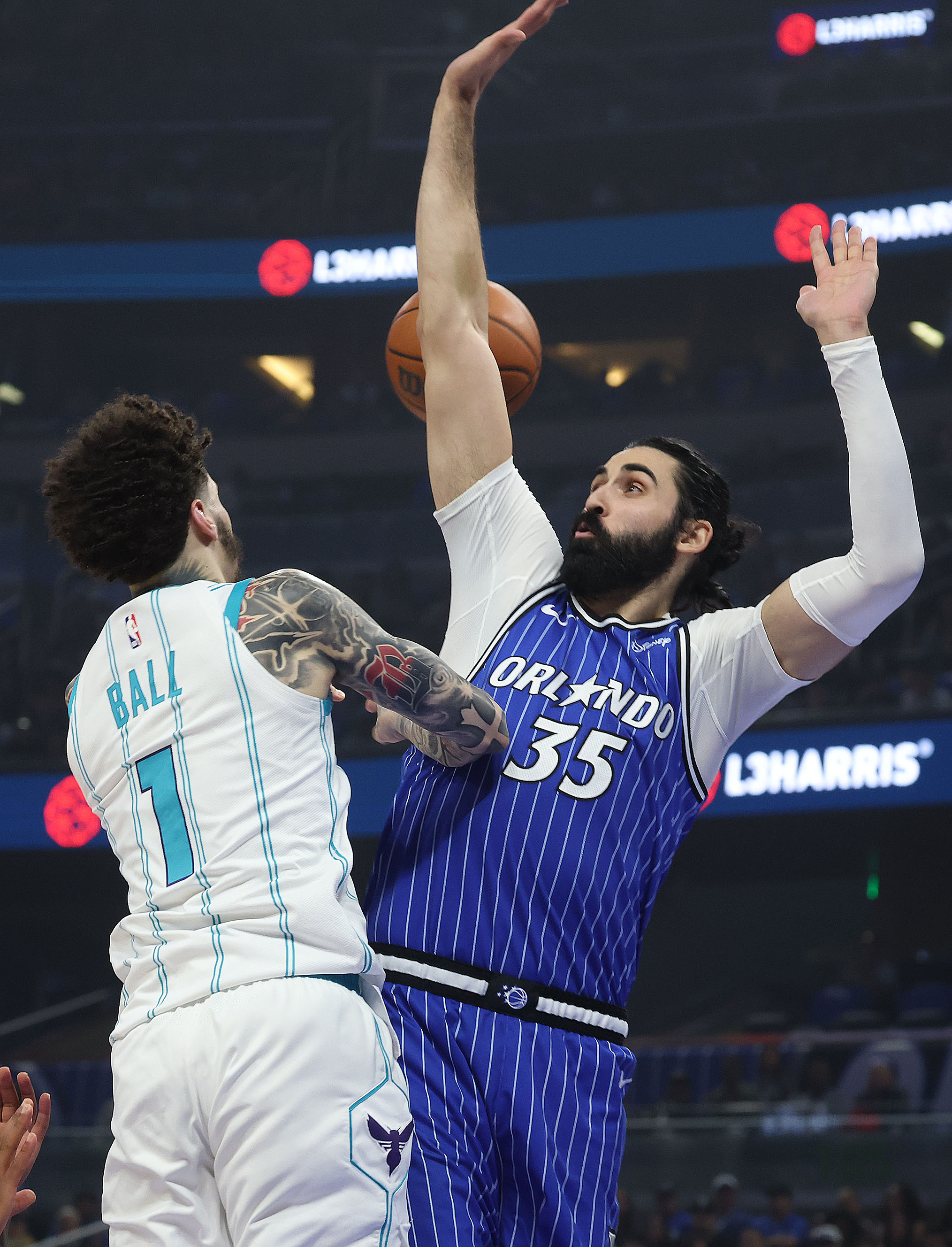 Charlotte guard LaMelo Ball (1) passes around Orlando center Goga...