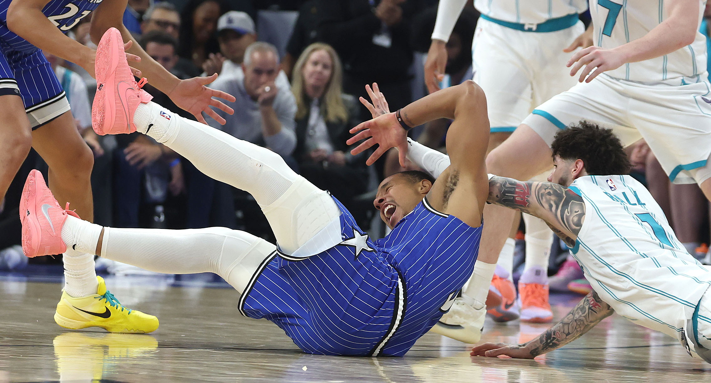 Orlando guard Desmond Bane (dark jersey) is fouled by Charlotte...