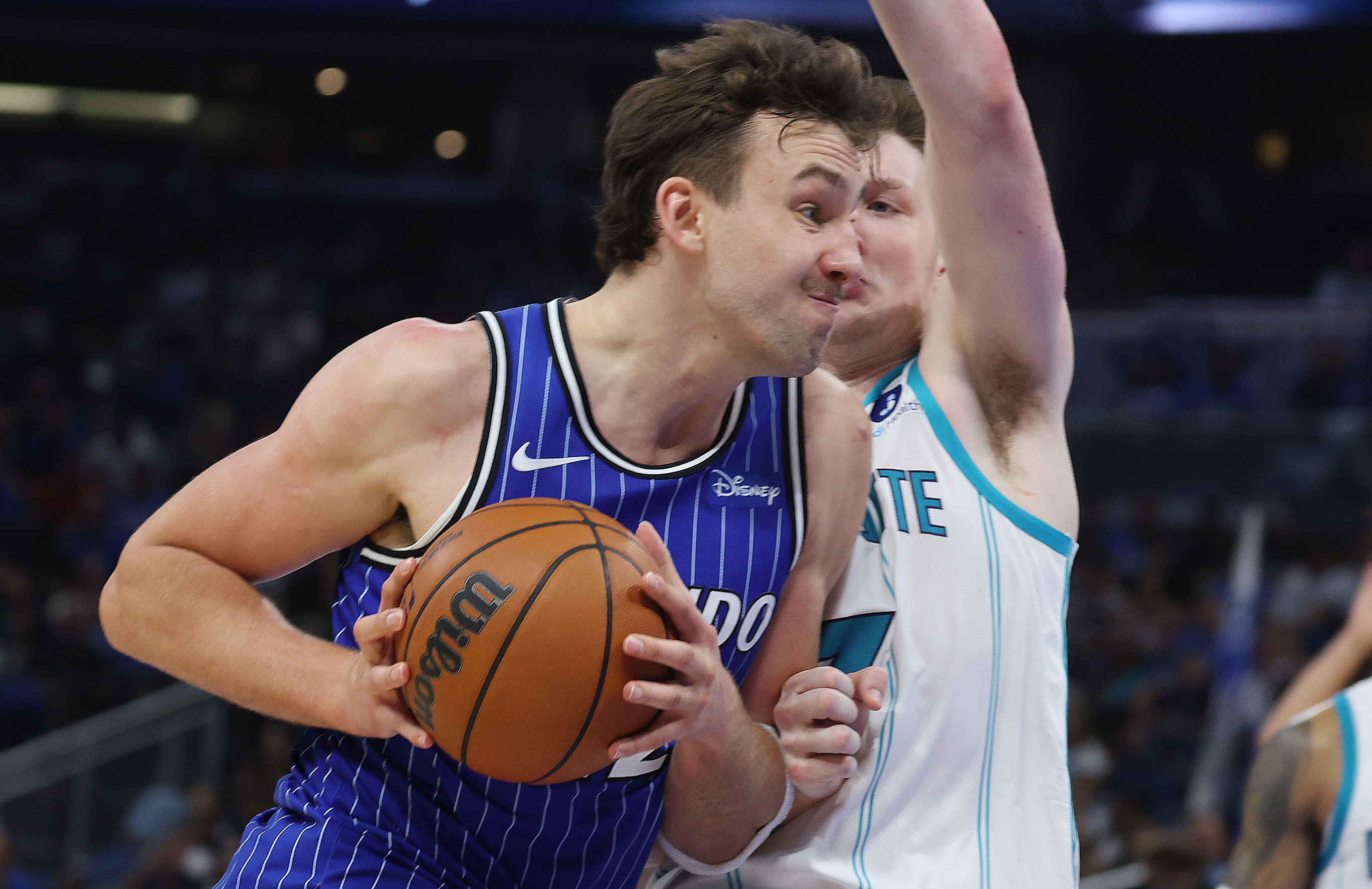 Orlando forward Franz Wagner (with ball) drives through Charlotte forward...