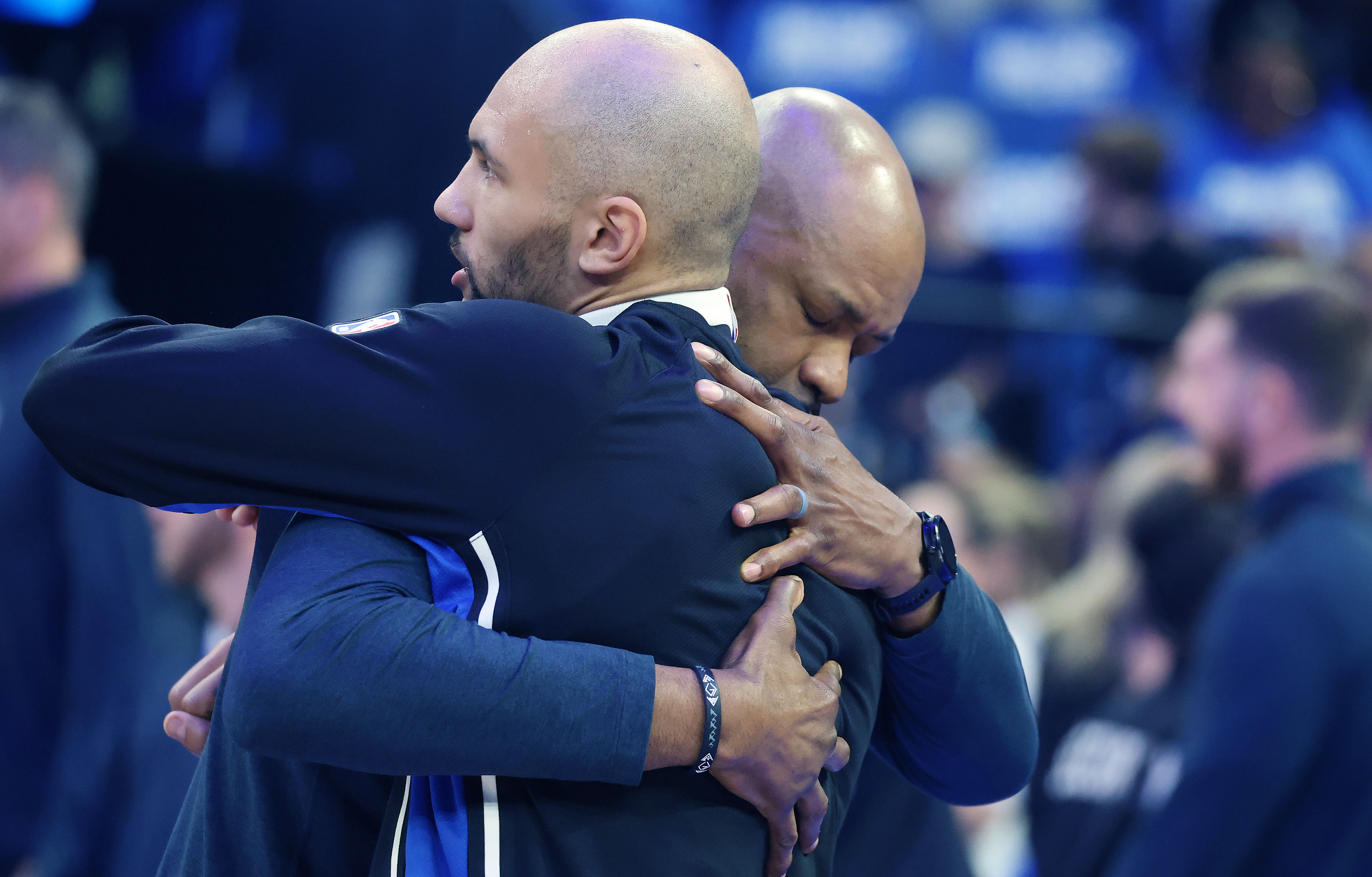 Orlando coach Jamahl Mosley (right) hugs Orlando guard Jalen Suggs...