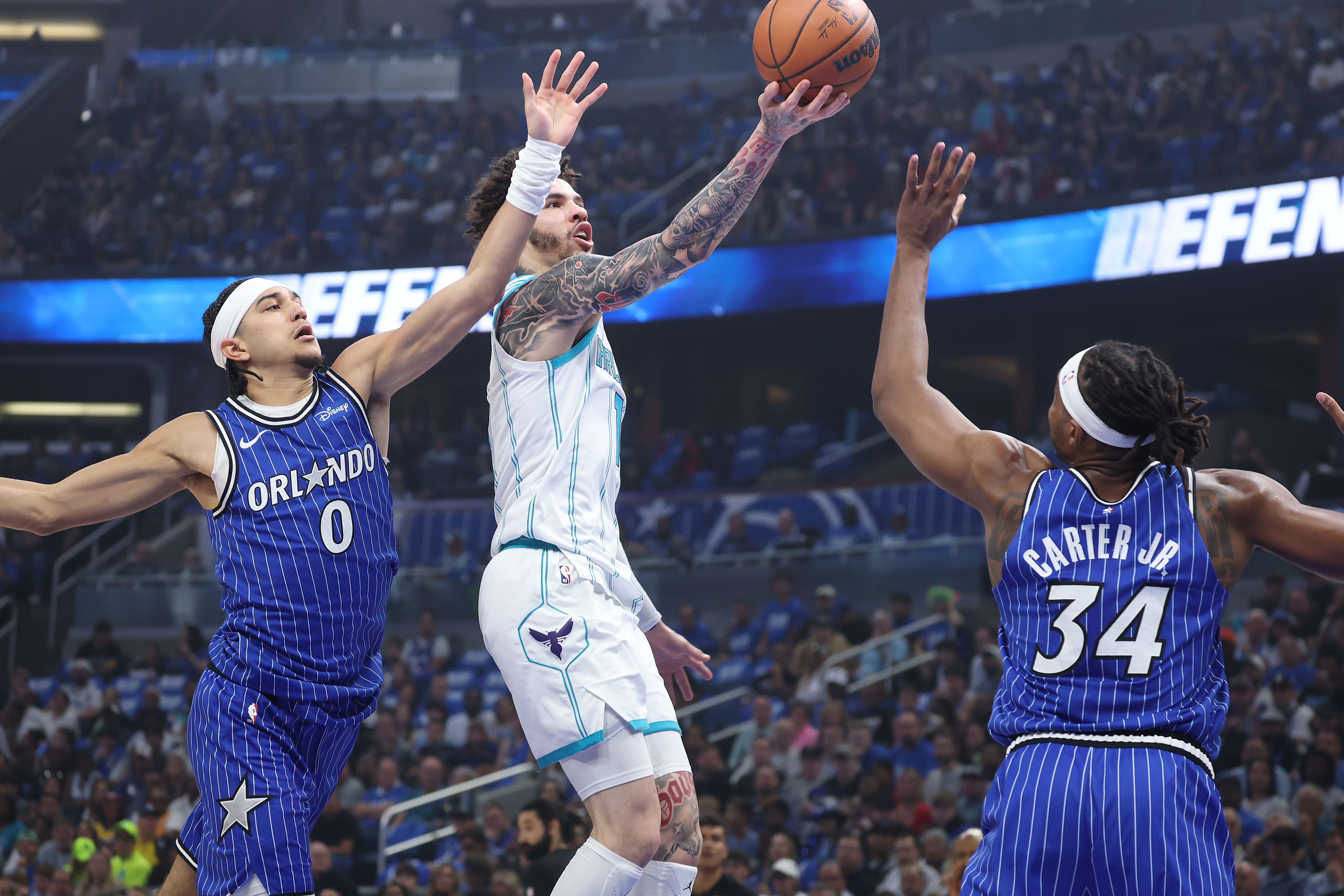 Orlando guard Anthony Black (0) and Orlando center Wendell Carter...