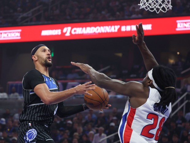 Magic guard Jalen Suggs (4) eyes a shot as Pistons forward Isaiah Stewart (28) defends during the first half of Saturday's Game 3 inside Kia Center. (Stephen M. Dowell/Orlando Sentinel)