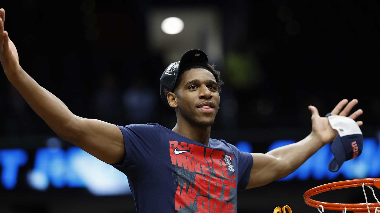 UConn Huskies forward Tarris Reed Jr. (5) cuts down the net after defeating the Duke Blue Devils in an Elite Eight game of the East Regional of the men's 2026 NCAA Tournament at Capital One Arena. 